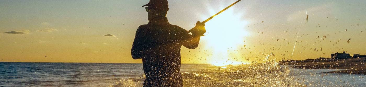 man fishing along the shore of Destin